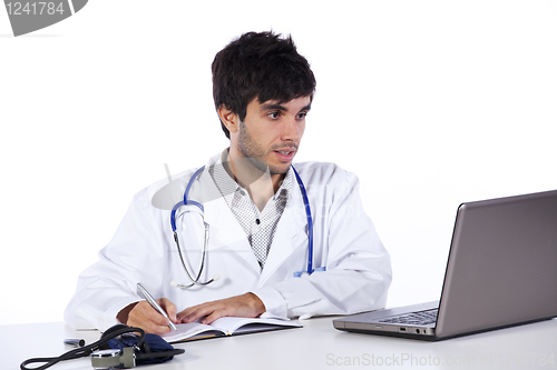 Image of frendly young doctor working with his laptop