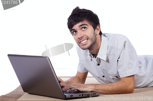 Image of Happy young man surfing the internet