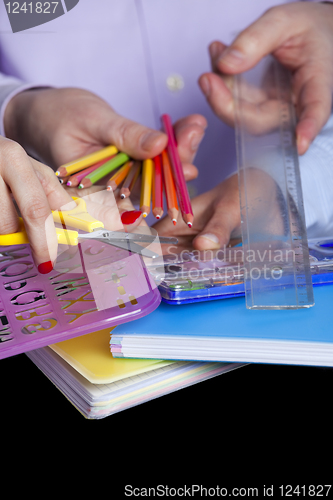 Image of Hands holding education objects