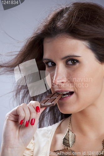 Image of Woman biting chocolate