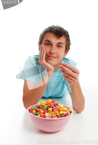 Image of Boy relaxing with bowl popcorn