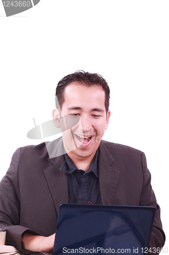 Image of Happy young man working on laptop computer, having fun
