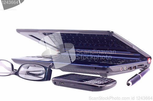 Image of Cell phone, laptop, sunglasses and pen isolated