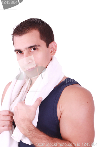 Image of A young man just finishes his workout and with towel over his shoulder 