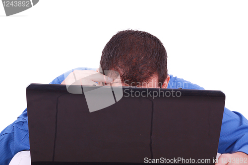 Image of A bald man hiding behind his laptop computer screen. 