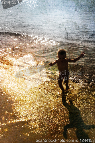 Image of child playing with the sea