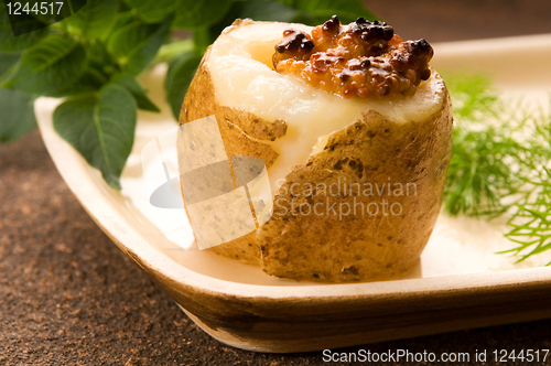 Image of Baked potato with sour cream, grain Dijon mustard and herbs