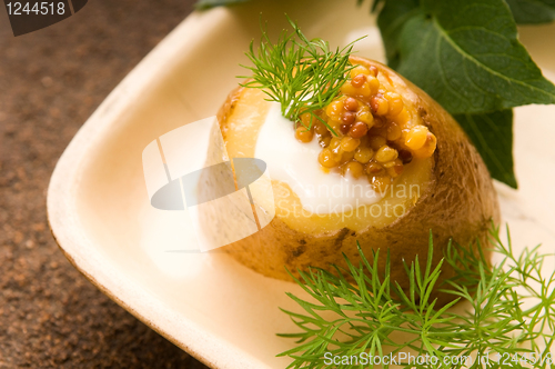Image of Baked potato with sour cream, grain Dijon mustard and herbs
