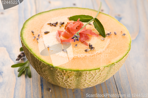 Image of fresh melon soup with parma ham and lavender flower