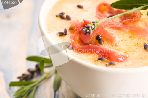 Image of fresh melon soup with parma ham and lavender flower