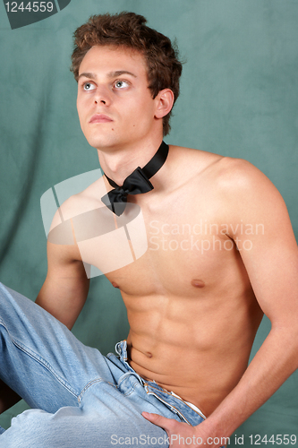 Image of Shirtless young man with bow tie