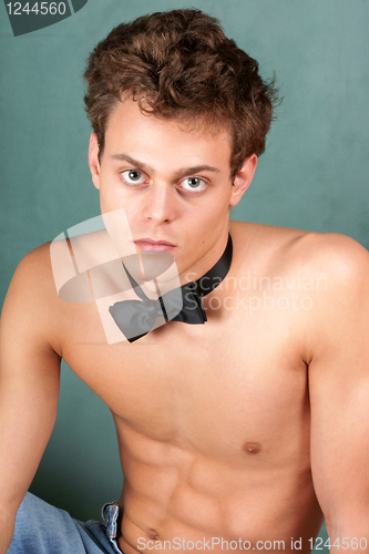 Image of Shirtless young man with bow tie