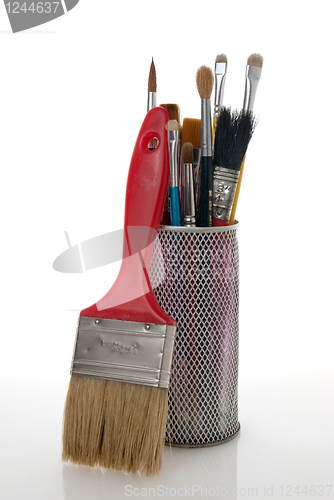 Image of Paintbrushes in a metal mesh holder