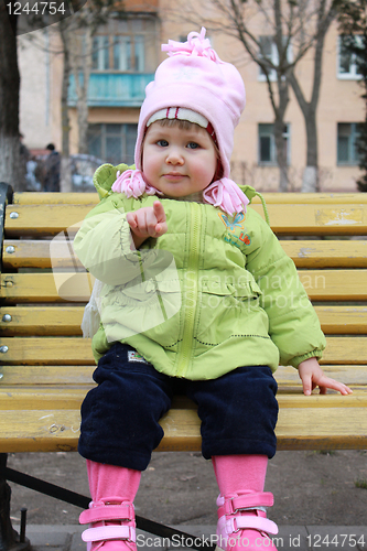 Image of girl sits on a bench