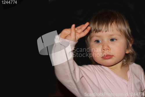 Image of child waves a hand