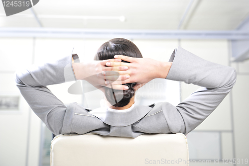 Image of businesswoman resting in the arm-chair   