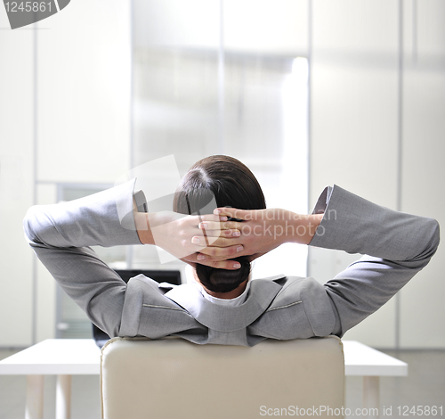 Image of businesswoman resting in the arm-chair   