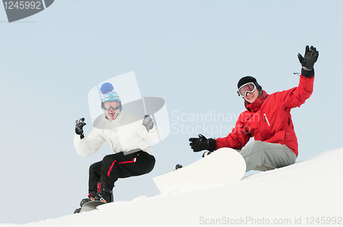 Image of Happy sportsman with snowboards