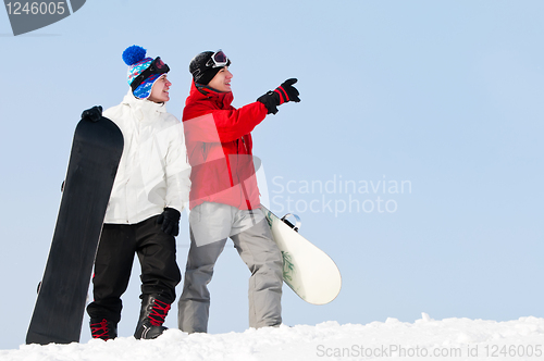Image of Happy sportsman with snowboards