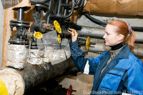 Image of woman engineer in a boiler room