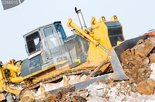 Image of bulldozer loader at winter frozen soil excavation works