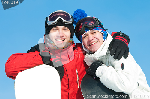 Image of Happy sportsman with snowboards