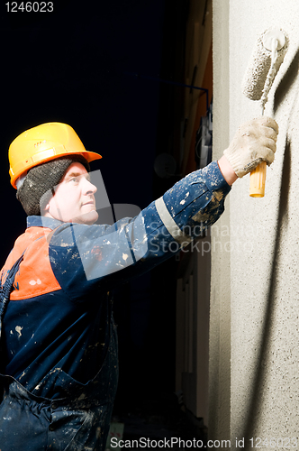 Image of builder plastering facade wall