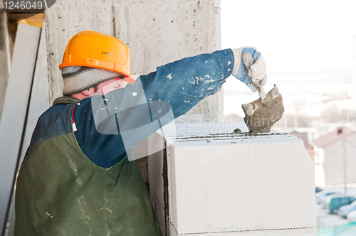 Image of worker mason at bricklaying work