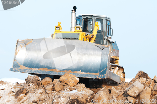 Image of bulldozer loader at winter frozen soil excavation works