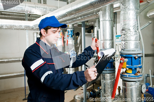 Image of heating engineer in boiler room