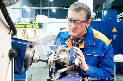 Image of worker at machine tool operating