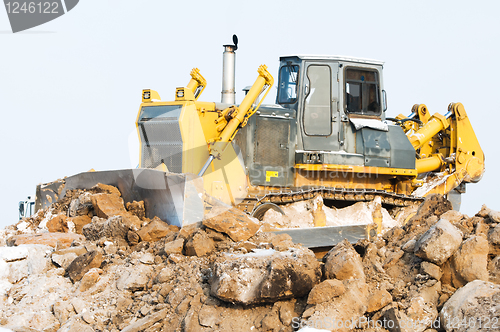 Image of bulldozer loader at winter frozen soil excavation works