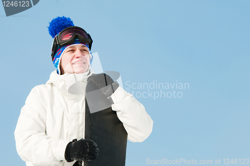 Image of Happy sportsman with snowboards