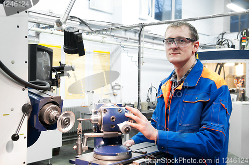 Image of worker at machine tool operating