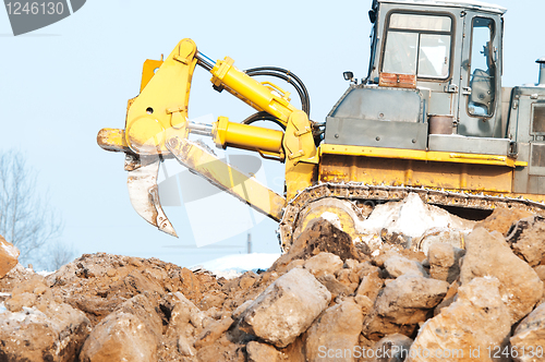 Image of bulldozer loader at winter frozen soil excavation works