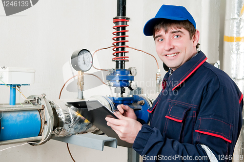 Image of heating engineer in boiler room