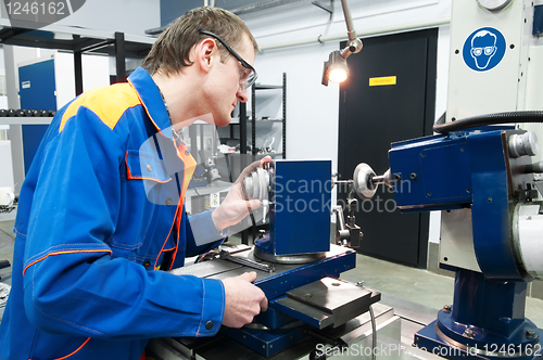 Image of worker at machine tool operating