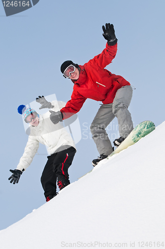 Image of Happy sportsman with snowboards