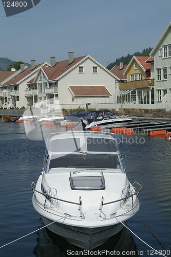 Image of Day-cruiser and water-front houses