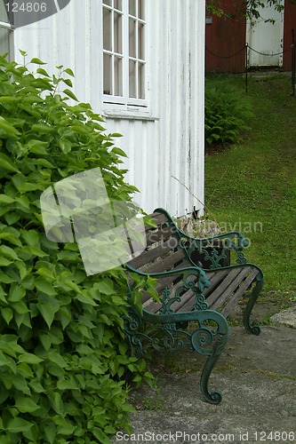 Image of Bench and old house