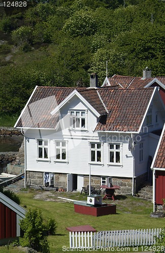 Image of Wooden houses in a garden by the sea