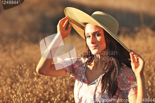 Image of Young Beautiful Woman on a Field in Summer Time