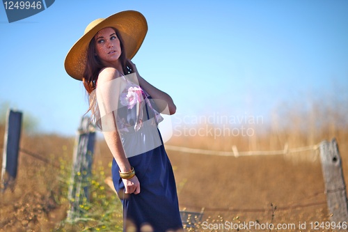 Image of Young Beautiful Woman on a Field in Summer Time