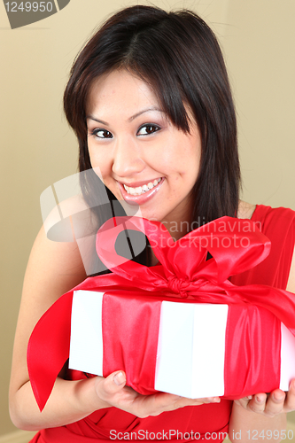 Image of Asian Woman Holding a Gift Package Wrapped With Ribbon