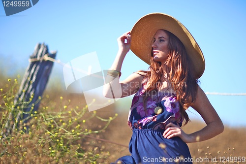 Image of Young Beautiful Woman on a Field in Summer Time