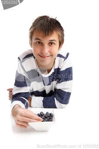 Image of Boy eating blueberries
