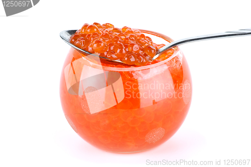 Image of Metal spoon and glass bowl with red caviar