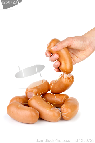 Image of Hand taking sausage isolated on the white background