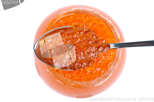 Image of Small metal spoon and glass bowl with red caviar (View from above)