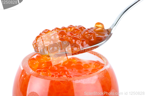 Image of Close-up of metal spoon and glass bowl with red caviar